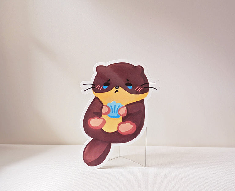 Otter Clutching A Blue Seashell Sticker